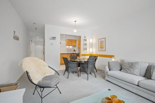 a living room with a couch and a table at Ambrose 23 Parking in Knokke