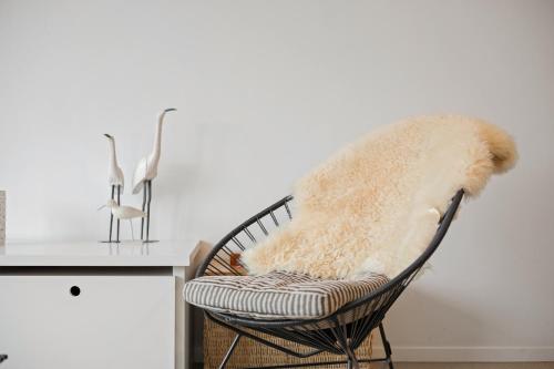 a chair with a blanket on it next to a counter at Ambrose 23 Parking in Knokke