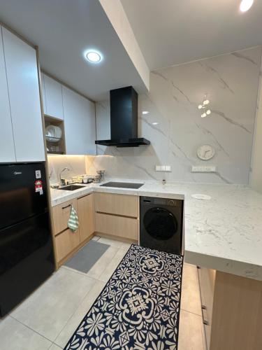 a kitchen with a black refrigerator and a dishwasher at Seri Kembangan Metacity, Cikgu Kabinet Empire, Equine Park,MRT Station, IOI mall, Putrajaya, Cyberjaya, Farm in the city, Uptown Equine in Seri Kembangan