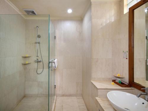 a bathroom with a shower and a sink at Grand Istana Rama Hotel in Kuta