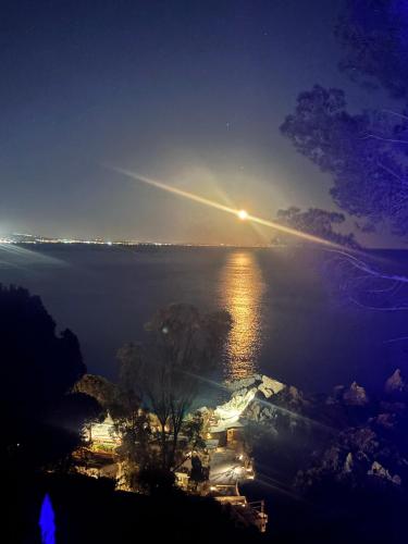 an island in the middle of the water at night at Sunsea House Copanello in Copanello