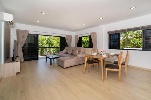 a living room with a table and a couch at The Hideout Beachfront in Patong Beach