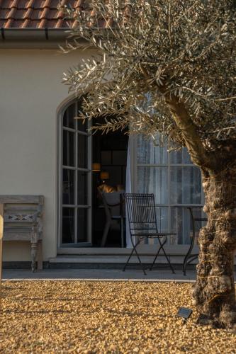a chair sitting on the porch of a house at BnB bergelen in Wevelgem
