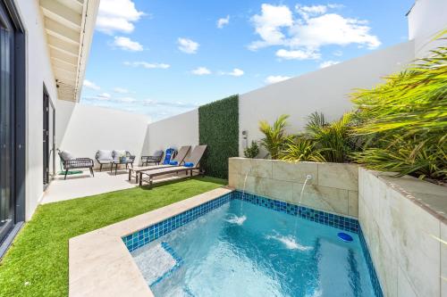 a swimming pool in the backyard of a house at Charming 2 BR Oasis in Oranjestad by Bocobay in Pos Abao