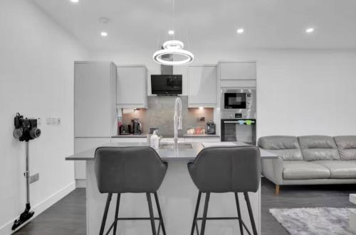 a kitchen with a table and two chairs and a couch at Skyline Studios Tower Bridge in London