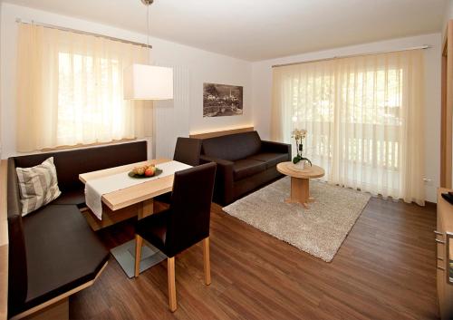 a living room with a couch and a table at Seppmair in Lagundo