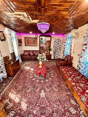 a living room with a couch and a large rug at Dilnaaz group of houseboats in Srinagar
