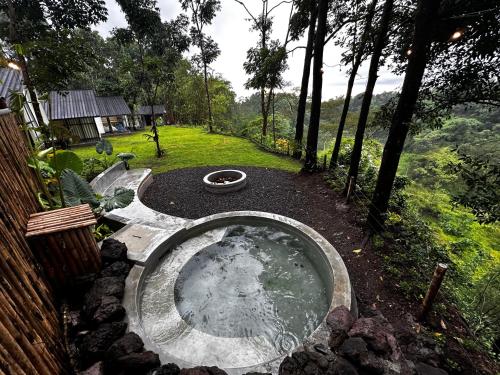 a small pool of water in a yard at villa heve glamping in Kaliurang