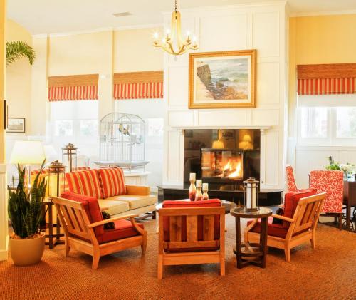 a living room with chairs and a fireplace at Coronado Beach Resort in San Diego