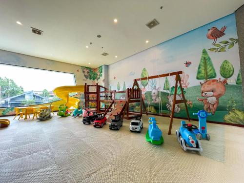 a childrens room with toys in front of a mural at Samara Resort in Batu