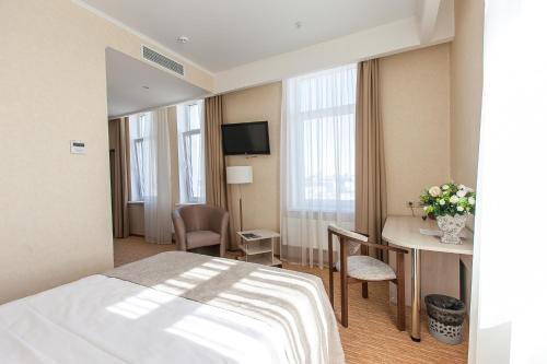 a hotel room with a bed and a table at Olymp Kazan in Kazan