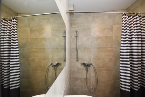 a bathroom with a shower with a toilet and a sink at Work & Stay Boardinghouse in Solingen in Solingen