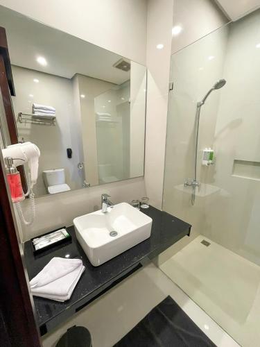 a bathroom with a sink and a mirror at Samara Resort in Batu