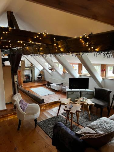 a living room with a couch and a table at Apartment Cats Forest in Großschönau