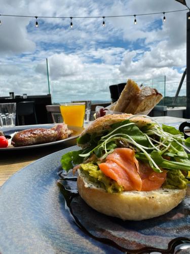a sandwich on a plate on a table at The Capital Trilogy Menlyn Maine in Pretoria