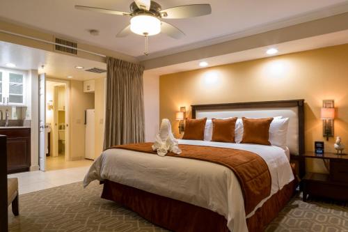 a bedroom with a large bed and a bathroom at Coronado Beach Resort in San Diego