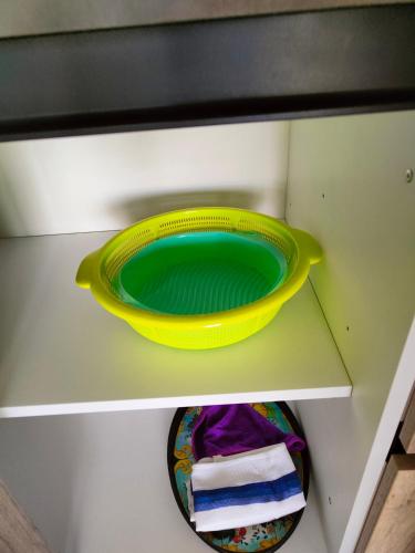 a yellow bowl sitting on top of a shelf at Infinity view residence in Sannat