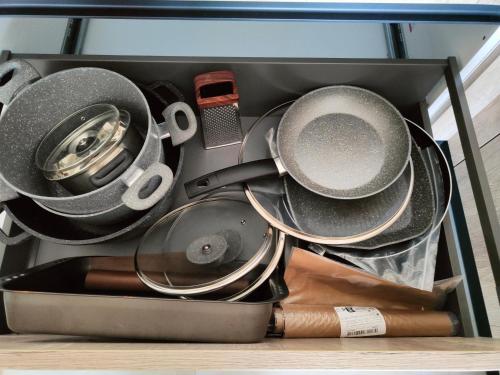 a drawer filled with pans and other utensils at Infinity view residence in Sannat