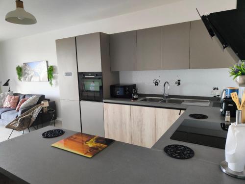 a kitchen with a sink and a counter top at Infinity view residence in Sannat