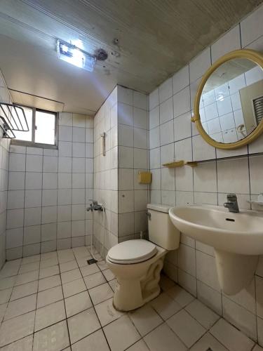 a bathroom with a toilet and a sink at HappyHealingHeaven in Hengchun