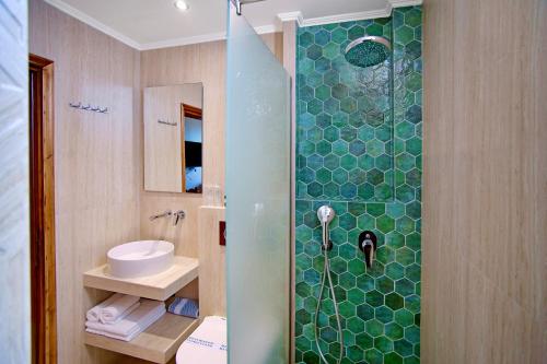 a bathroom with a shower with a toilet and a sink at Kyparissia Beach Hotel in Kyparissia