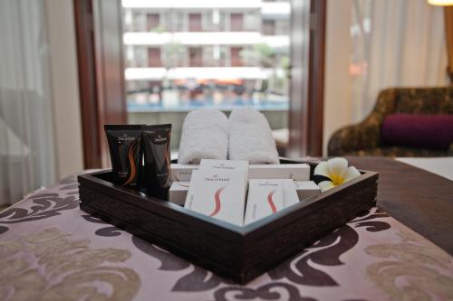 a tray with cards on a table in a hotel room at Sun Island Hotel & Spa Kuta in Kuta