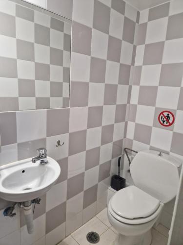 a bathroom with a toilet and a sink at EstellApartments in Athens