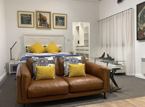 a living room with a couch and a bed at Cordwainer Eco Studio in Deloraine