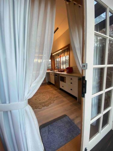 an open door with a curtain in a bathroom at Cordwainer Eco Studio in Deloraine