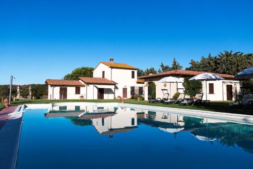 a swimming pool in front of a house at Poggio Sasseta in Montiano