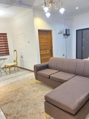 a living room with a couch and a chair at Ayaa Grace in Accra
