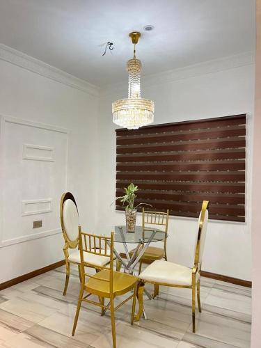 a dining room with a glass table and chairs at Ayaa Grace in Accra