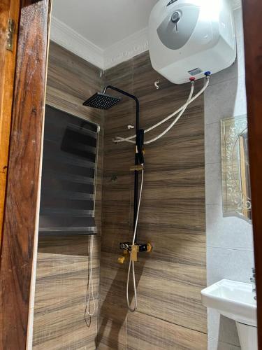 a shower in a bathroom with a toilet and a sink at Ayaa Grace in Accra