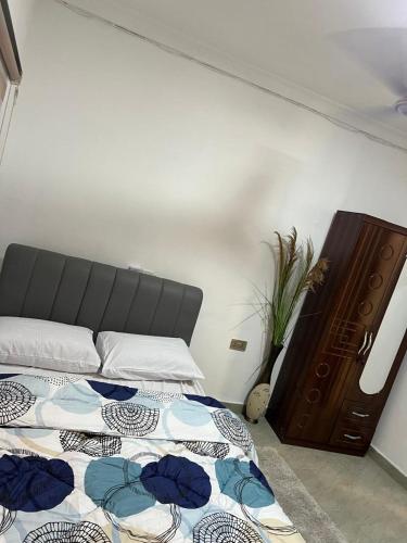 a bedroom with a bed and a dresser at Ayaa Grace in Accra