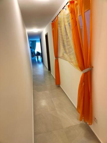 a hallway with orange curtains in a room at Infinity view residence in Sannat