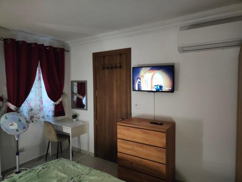 a bedroom with a bed and a tv on the wall at Infinity view residence in Sannat
