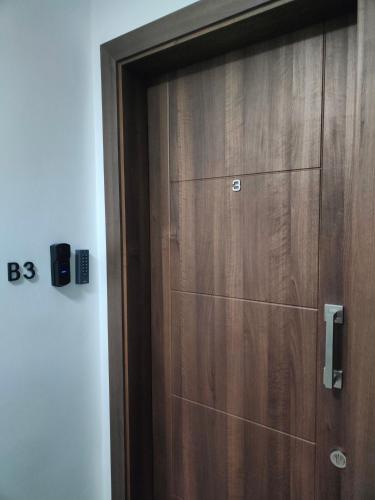 a wooden closet with a wooden door in a room at Infinity view residence in Sannat