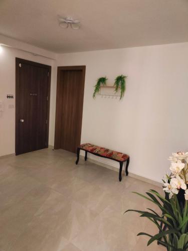 a living room with a bench with a plant at Infinity view residence in Sannat
