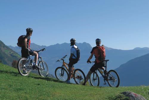 a group of three people riding bikes on a hill at Casa Santa Maria in Folgaria