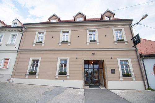 a large building with a door in front of it at Hotel Maribor & Garden Rooms in Maribor
