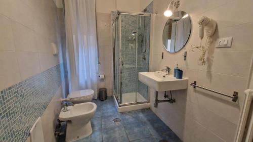 a bathroom with a sink and a toilet and a shower at Rooms hub Portarotese in Salerno