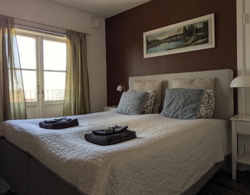 a bedroom with a bed with two towels on it at Brunsbo G:a Biskopsgård Hotell & Konferens in Skara