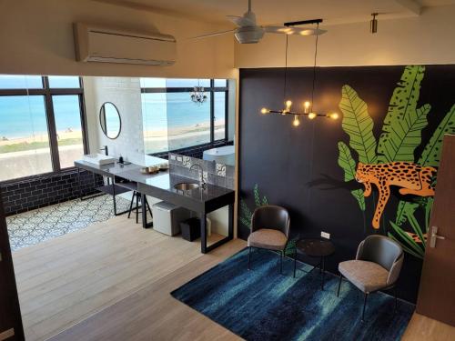 a room with a desk with a cheetah on the wall at Beachcastle & Sea View Villa in Magong