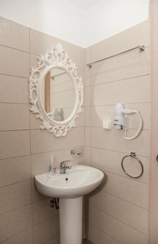 a bathroom with a sink and a mirror at Fantastic Matala 2 in Matala