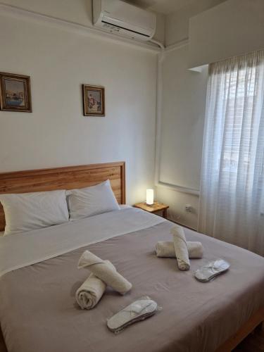a bedroom with a bed with towels on it at EstellApartments in Athens