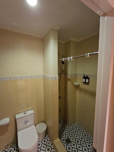 a bathroom with a toilet and a shower at Ciello Accomodation in Cagayan de Oro