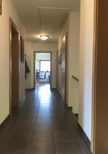 an empty hallway in a building with a tile floor at Astegg, Apart in Finkenberg