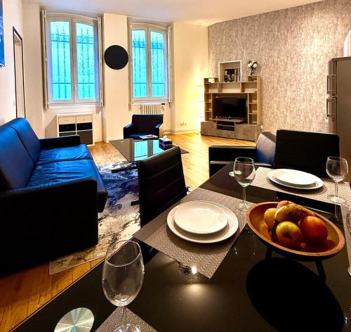 a living room with a table with a bowl of fruit on it at Family Champs Elysées appartement in Paris