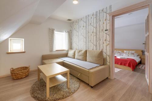 a living room with a couch and a bed at Dom Nad Wodospadem pod Śnieżnymi Kotłami in Jelenia Góra-Jagniątków