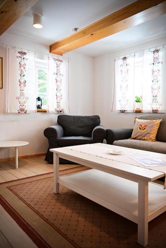 a living room with a couch and a table at Dom Nad Wodospadem pod Śnieżnymi Kotłami in Jelenia Góra-Jagniątków